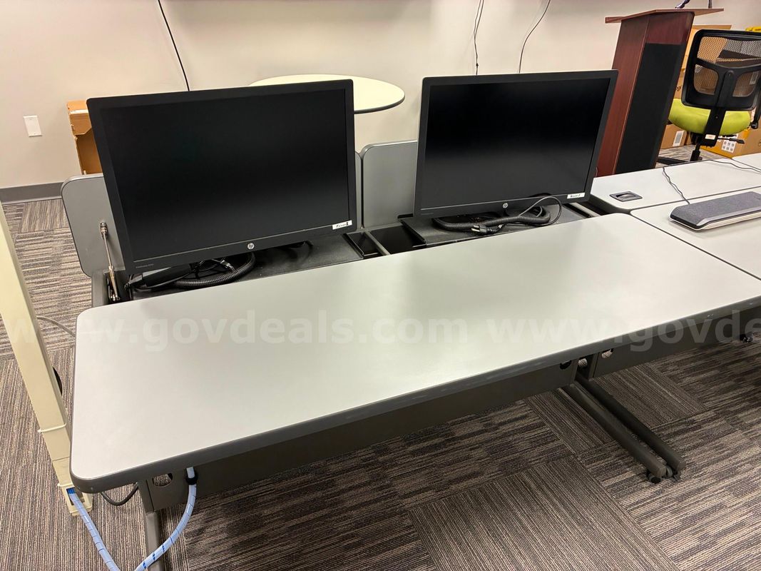 Desks with and without monitors, round table, cabinet