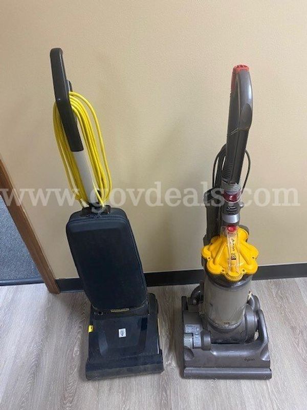 Two old broken vacuums, one Dyson and one Karcher.