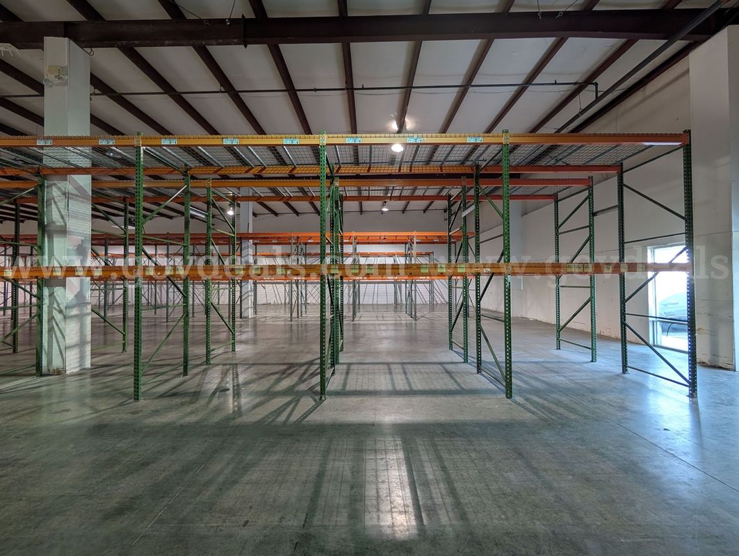 Commercial warehouse pallet racking system being sold as one complete lot.