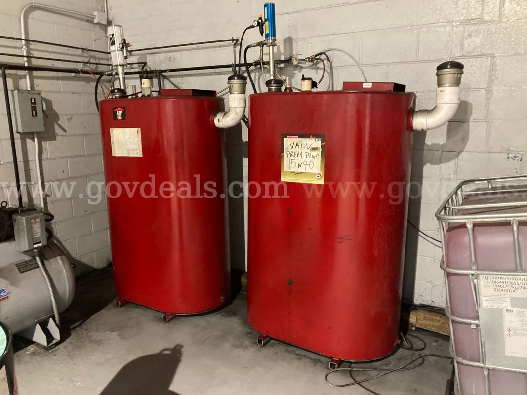 Lot of 2 large tanks - one half full of automatic transmission fluid, one 1/4 full of 15W40