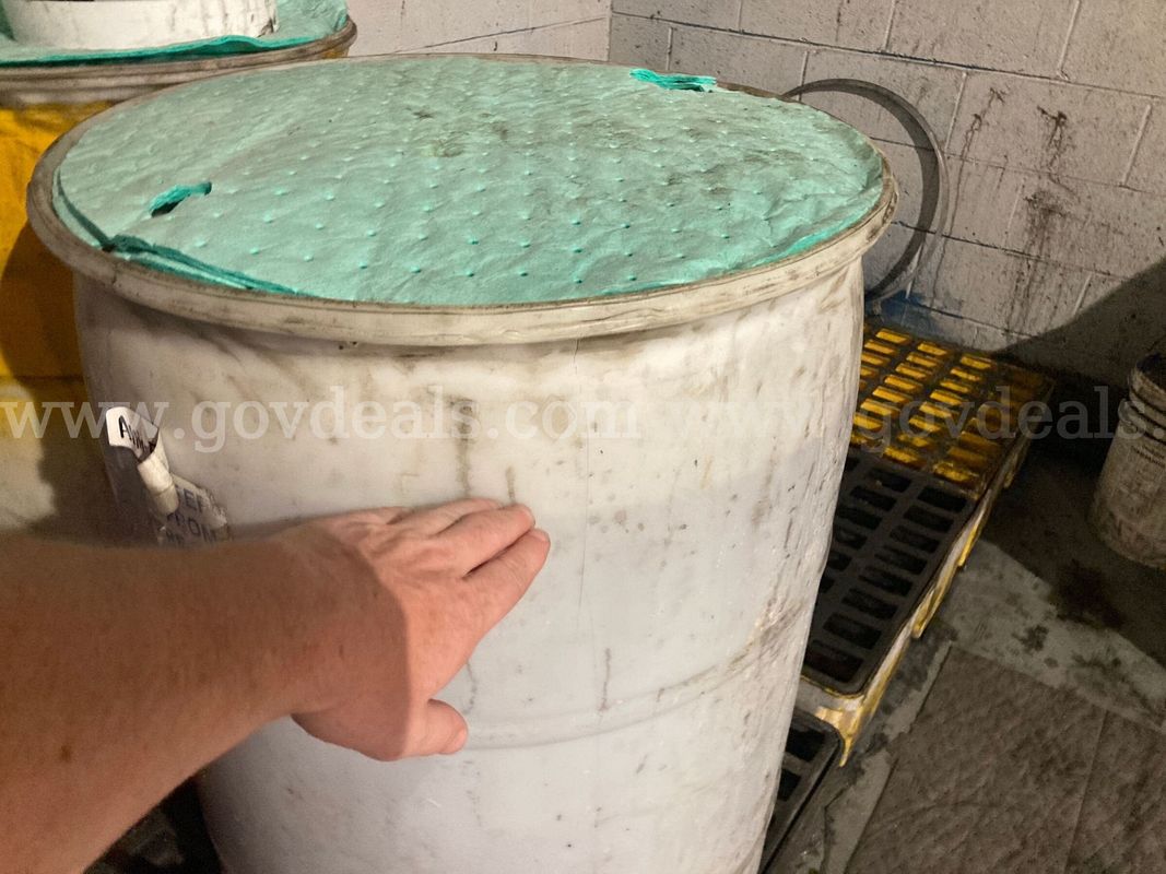Lot of 2 55gallon Drums and 3 5gallon buckets containing antifreeze and industrial cleaner