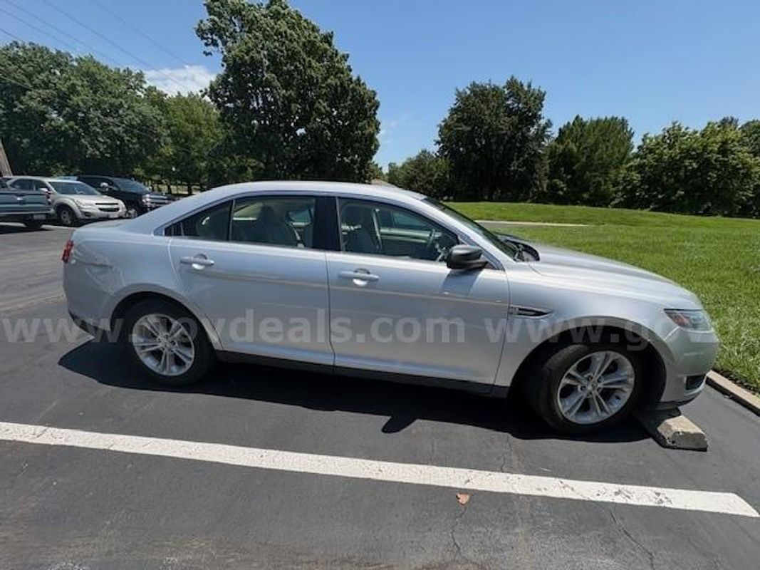 2016 Ford Taurus; (180,083 Miles).