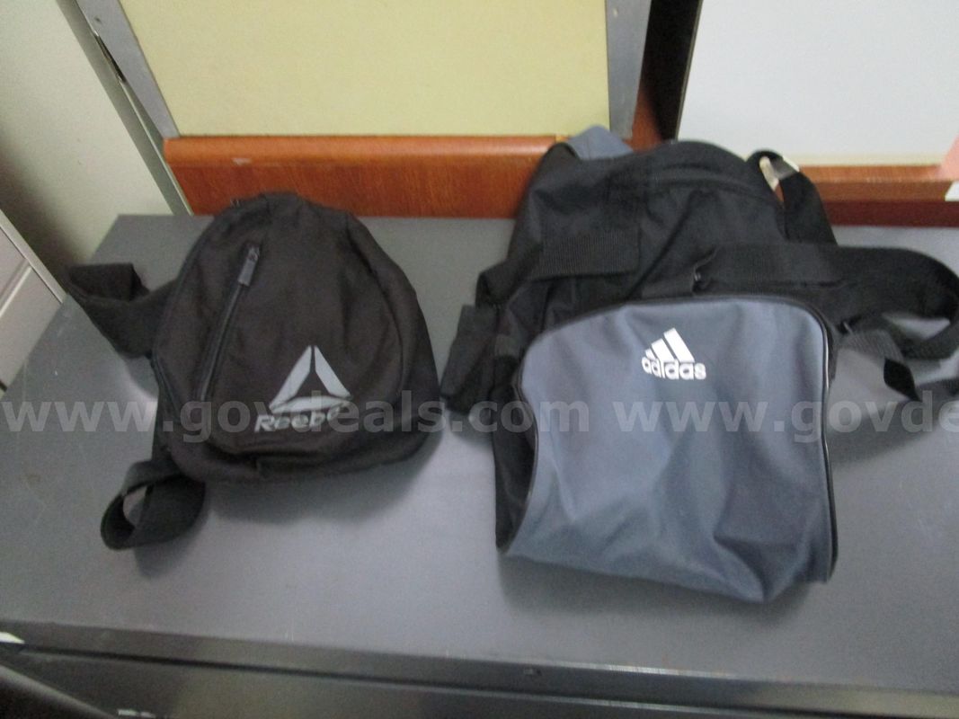 (1) USED ADIDAS DUFFLE BAG; (1) USED BLACK, REBOK SMALL BACKPACK