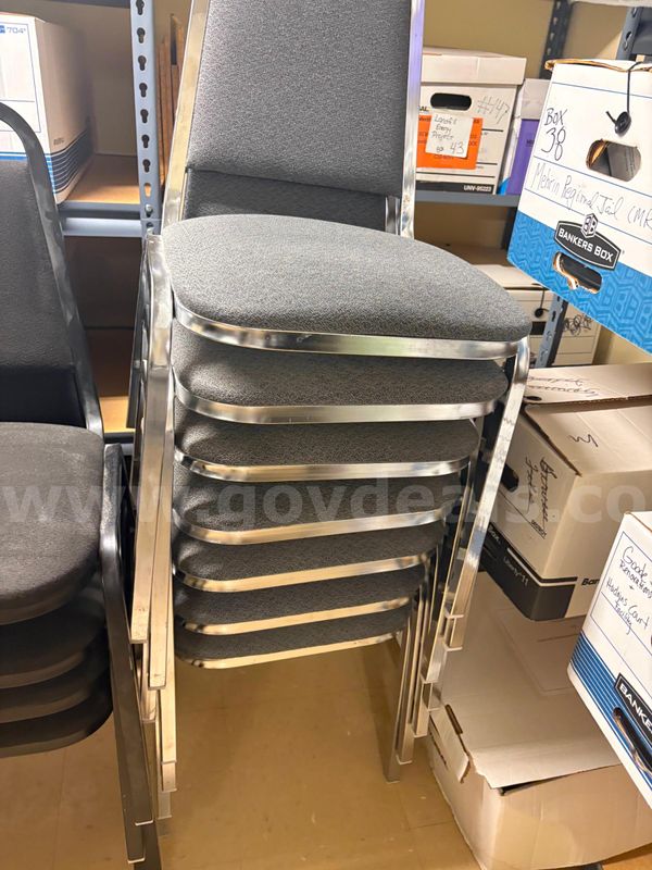 15 stacking banquet/conference chairs—Gray upholstered metal-frame stacking chairs.