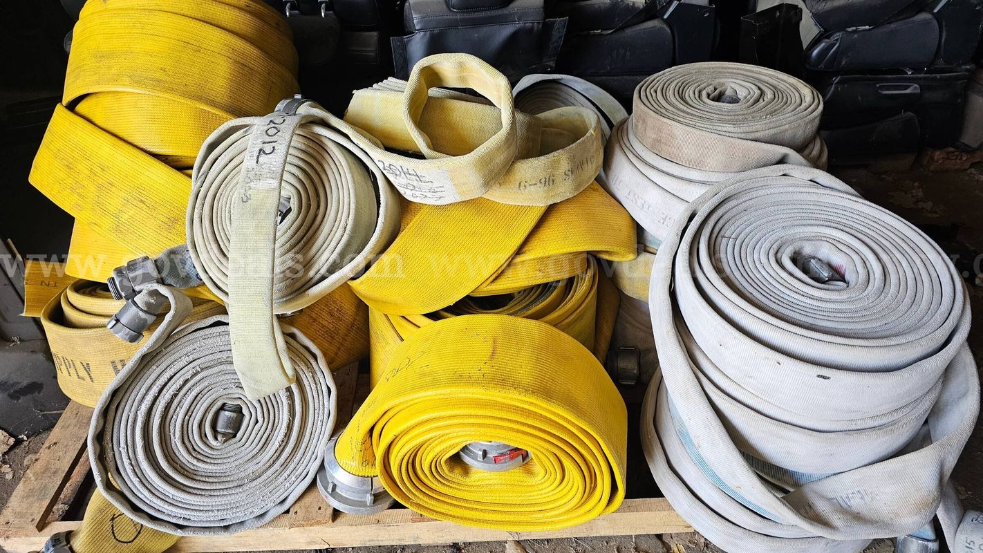 Large assortment of used fire hose for sale.