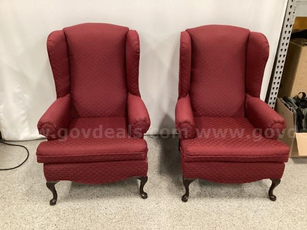 Two Burgundy Upholstered Wing Chairs