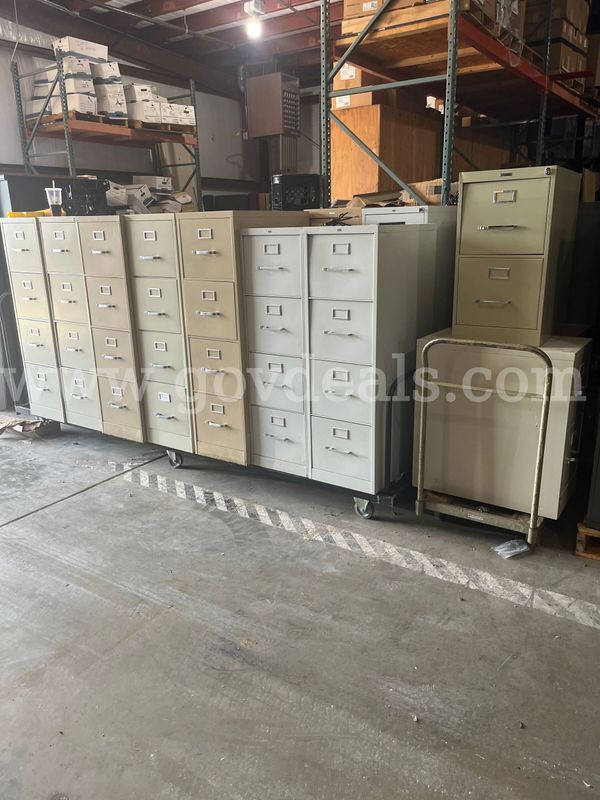 Lot of used filing cabinets. Approx eighteen 4 drawer and three 2 drawer metal file cabinets.