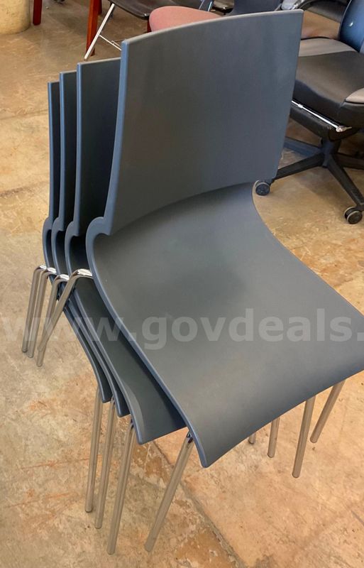 lot of 4 grey plastic chairs