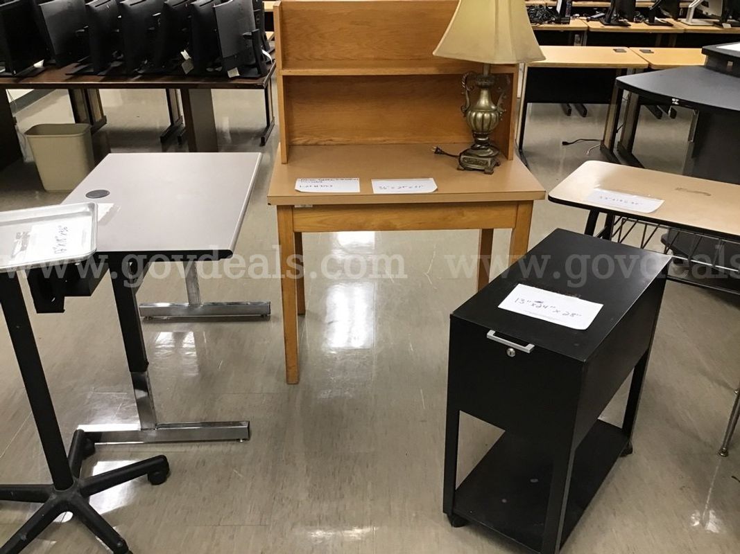 Miscellaneous desks, a filing cabinet and a tray table