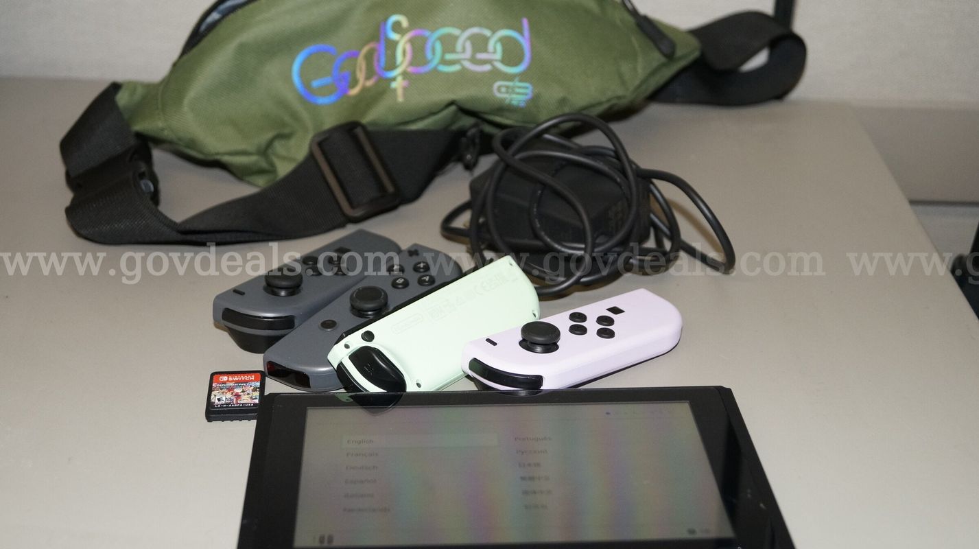 Nintendo Switch with 2 sets of controllers, charger and fanny pack includes 1 game MarioKart