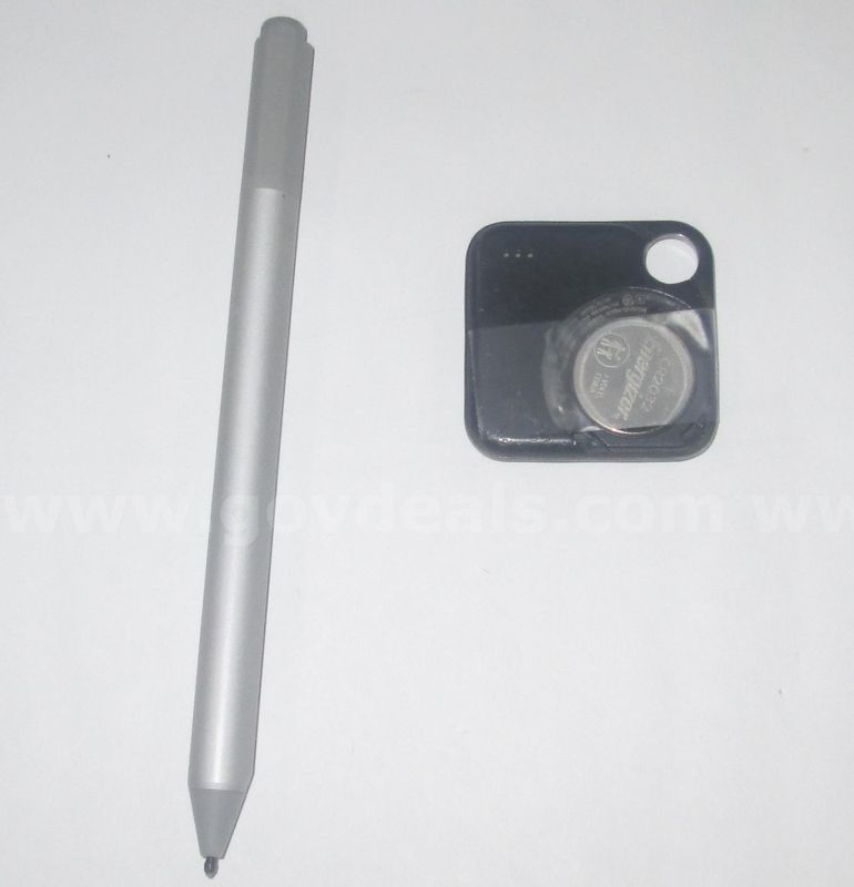 One Microsoft surface pen and a Bluetooth tracker