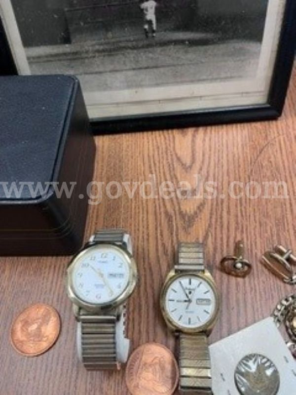 1 Small lot containing: 2 watches, cuff links, 1 necklace, 1 bracelet, and a framed photo of "The Catch"